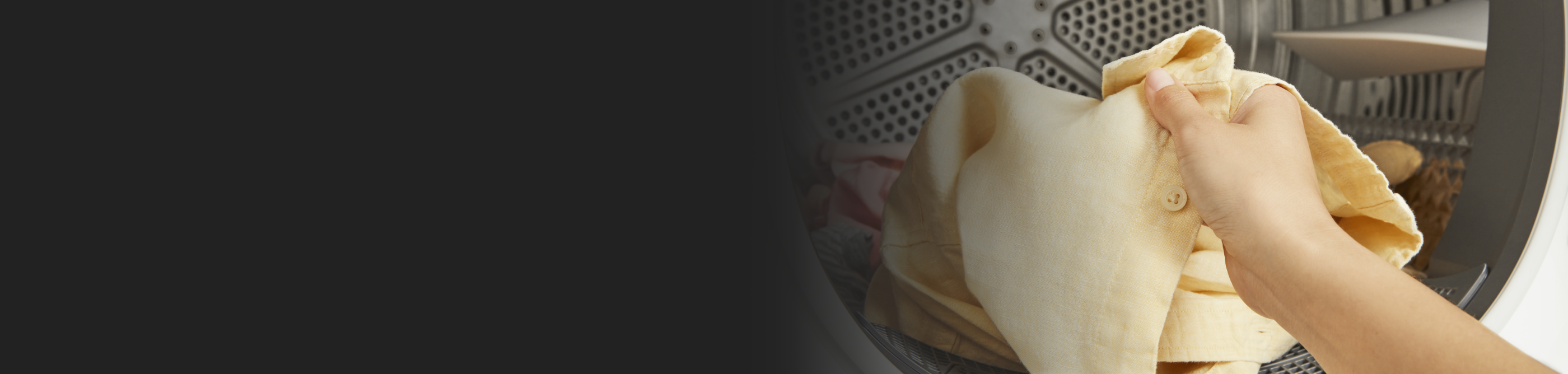 Person removing shirt from dryer