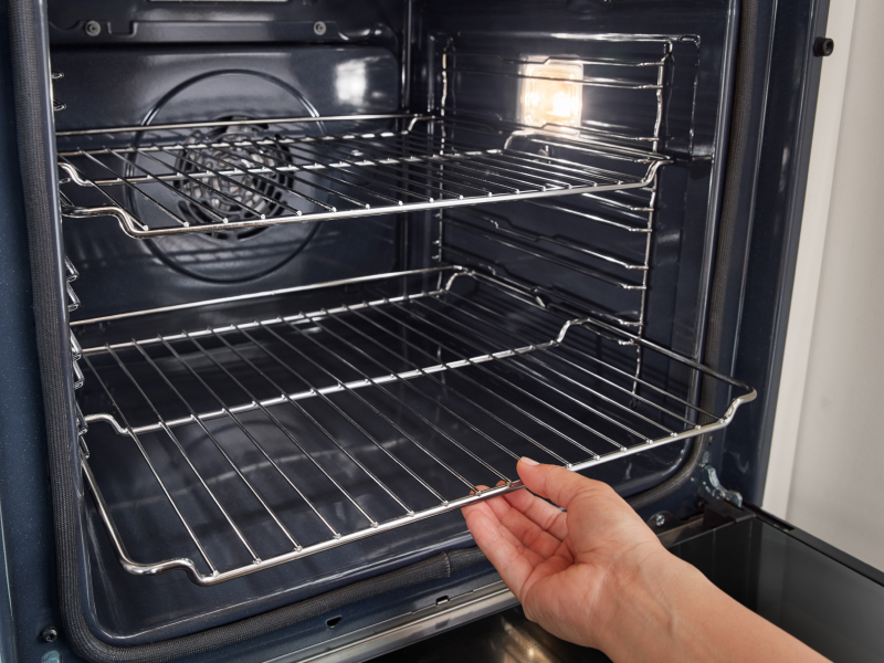 Person pulling out lower oven rack Person pulling out lower oven rack