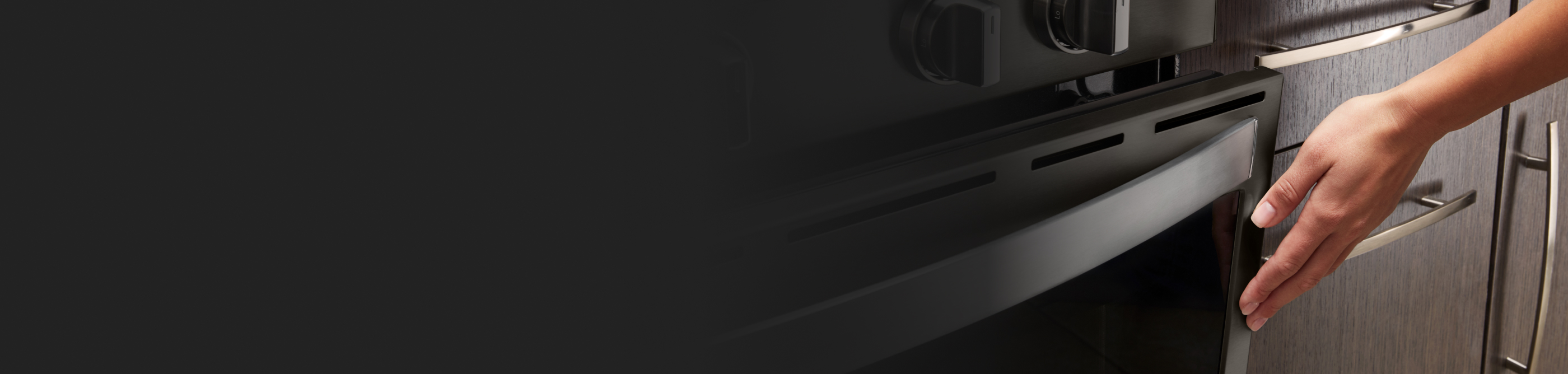 Person closing an oven door