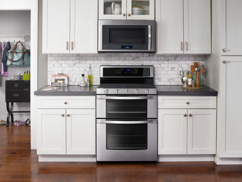 Silver double oven set into white cabinetry Silver double oven set into white cabinetry