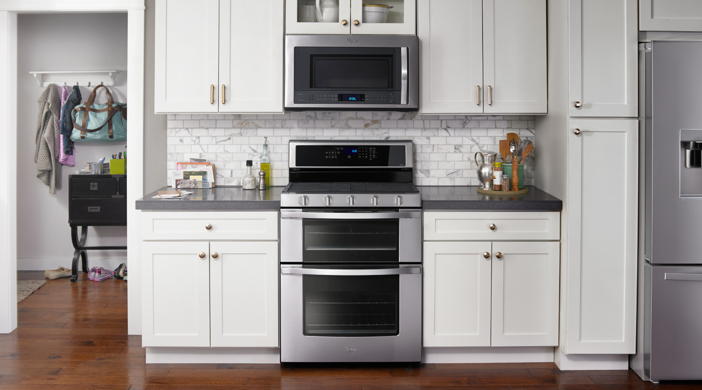 Silver double oven set into white cabinetry Silver double oven set into white cabinetry
