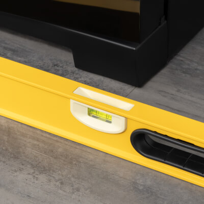 Close-up of leveler in front of refrigerator