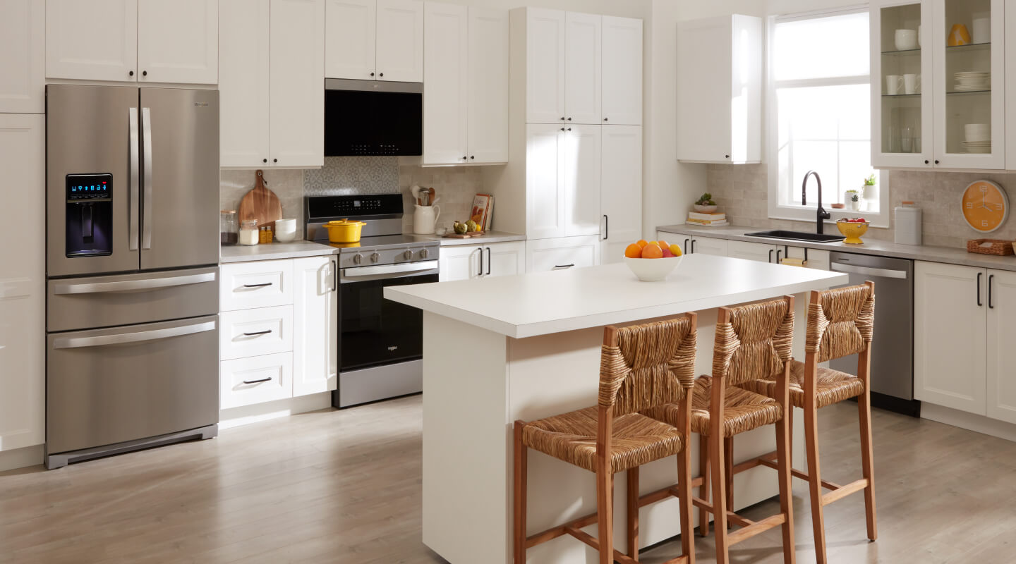Stainless steel multi-door refrigerator in white cabinetry