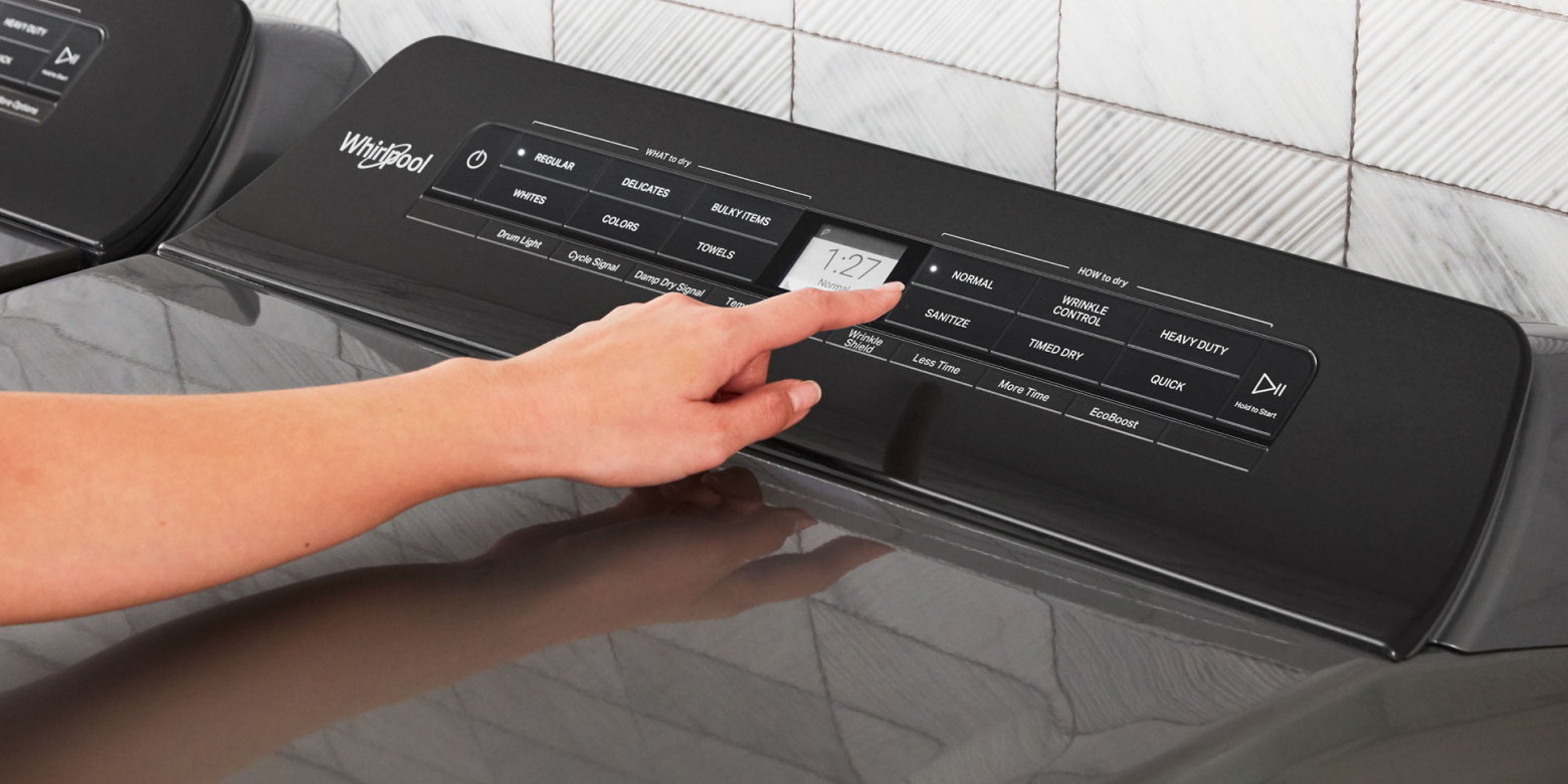 Person selecting a dryer cycle on a Whirlpool® dryer Person selecting a dryer cycle on a Whirlpool® dryer