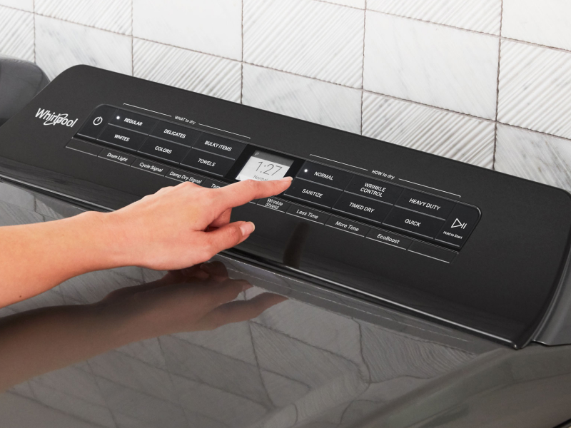 Person selecting a dryer cycle on a Whirlpool® dryer Person selecting a dryer cycle on a Whirlpool® dryer