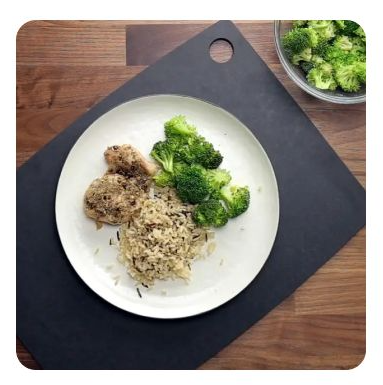 Chicken, wild rice and broccoli on a white plate