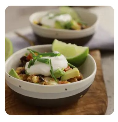 A bowl of quinoa casserole with lime and sour cream