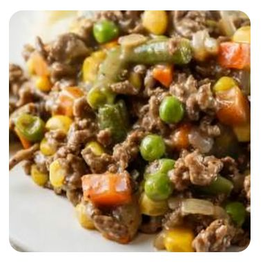 Close up of ground beef mixed with peas, carrots and corn