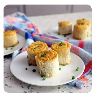 A plate of three grilled cheese pin wheels
