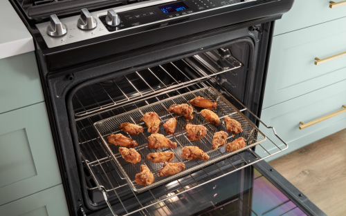 Chicken wings inside an air fryer basket