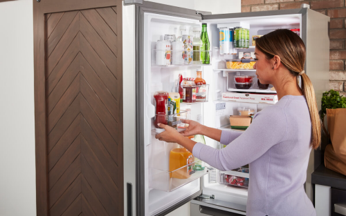 Person removing food from a refrigerator