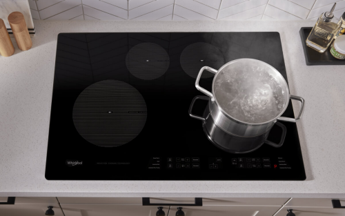 A pot of water boiling on an induction cooktop