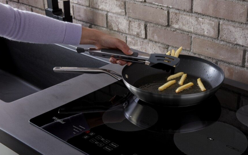 French fries being cooked on an electric stovetop