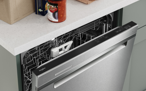 A dishwasher door slightly ajar