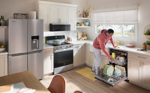 A man unloading his dishwasher