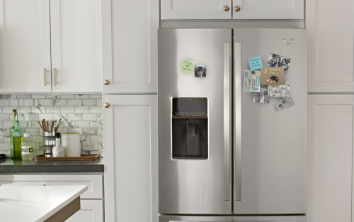 A refrigerator with a photo and note stuck onto it