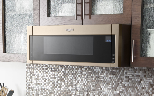 Bronze Whirlpool® low profile microwave below brown cabinetry