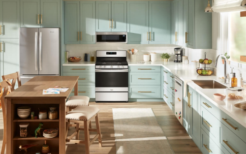 A bright kitchen with blue cabinets and white countertops