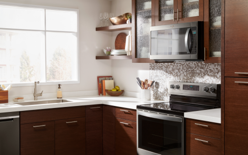 Wood cabinets and kitchen counter with microwave and oven