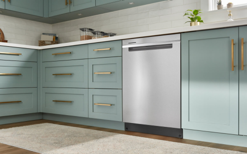 A Whirlpool® Dishwasher surrounded by teal cabinetry