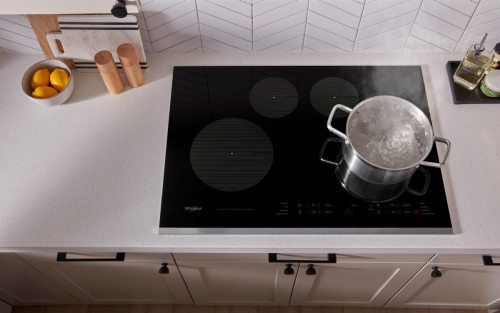 A pot of water boiling on an induction cooktop