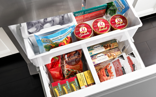 White freezer drawers opened showing a variety of frozen foods