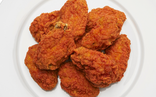 Several pieces of fried chicken on a plate