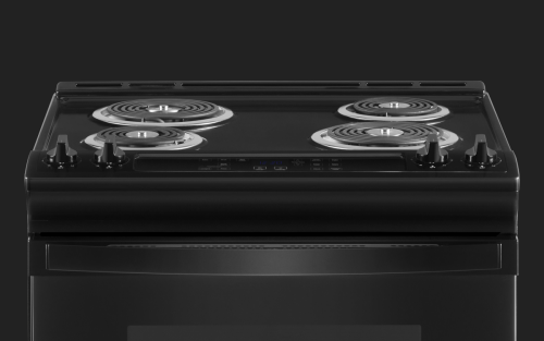 A closeup of a Whirlpool® electric oven cooktop with coil burners.