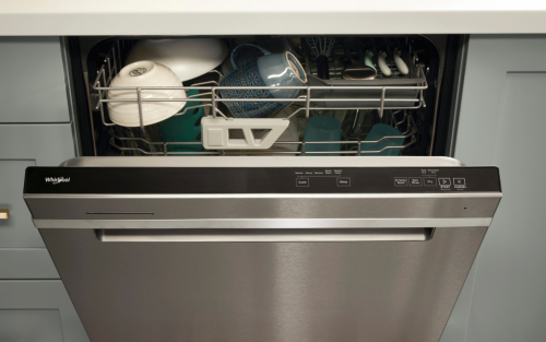 Front of open dishwasher with pocket handle and dishes inside