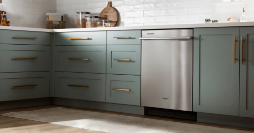 A Whirlpool® Dishwasher surrounded by teal cabinetry