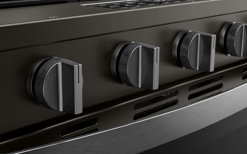 Closeup of the dials on the front of an oven