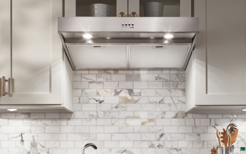 Stainless steel range hood under a cabinet