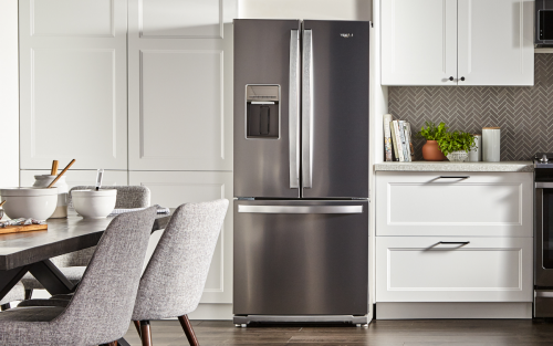 Modern kitchen with white cabinets and Whirlpool® stainless steel French door refrigerator and Whirlpool® range