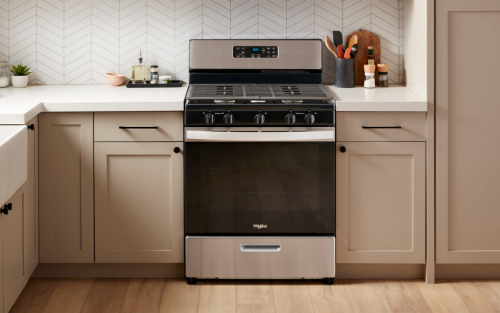 A Whirlpool® Range surrounded by tan cabinetry