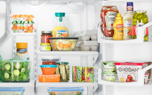 A Whirlpool® refrigerator loaded with a variety of foods