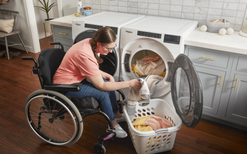 Person in a wheelchair using a Whirlpool® dryer