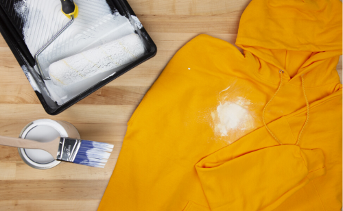 A white paint stain on a yellow sweatshirt