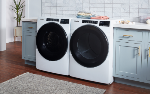 White front-load washer and dryer in a laundry room