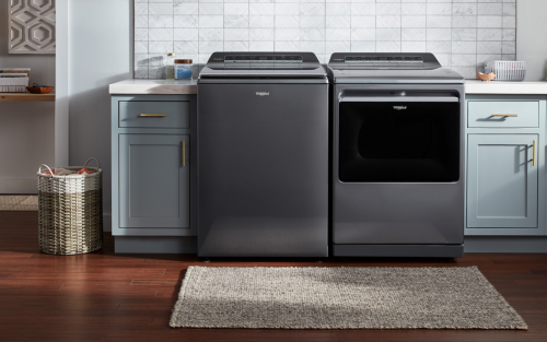 Whirlpool® front-load washer and dryer in laundry room with blue cabinetry