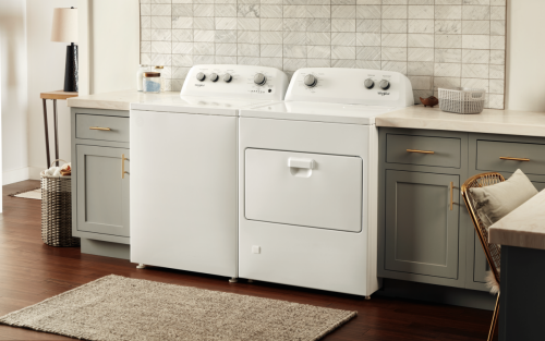 A white Whirlpool® washer and dryer pair in a laundry room