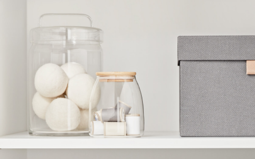 Wool dryer balls on a counter in a glass jar