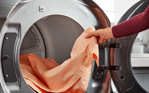 Person removing dress shirt from dryer