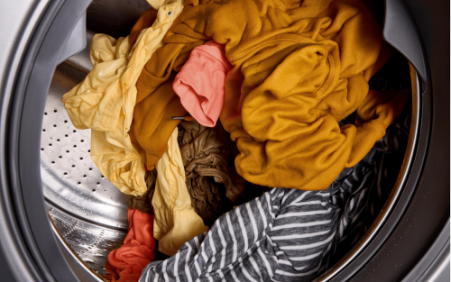 Colored clothes tumbling inside of washer