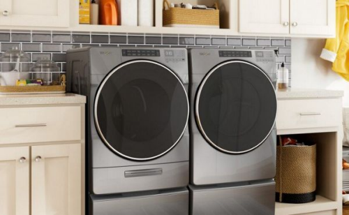 Front load chrome washer and dryer in a laundry room