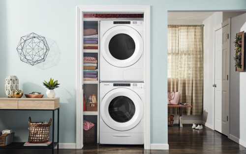 White Whirlpool® Stacked Washer and Dryer in a laundry closet