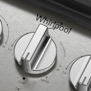 A closeup of the knobs/controls on a gas cooktop