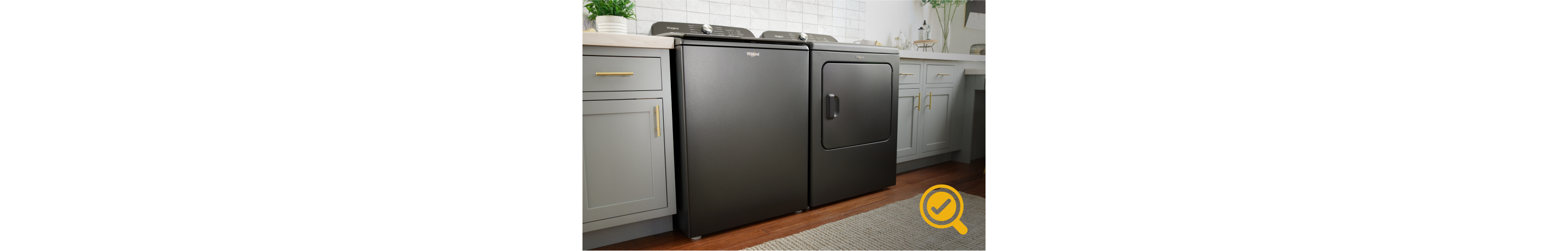 A laundry room with a Whirlpool® Top Load Washer and Dryer