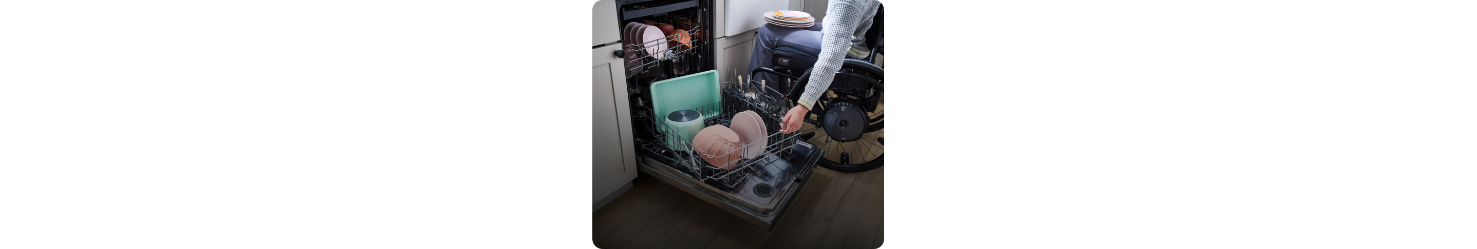 A person unloading dishes from the Spin&Load Rack