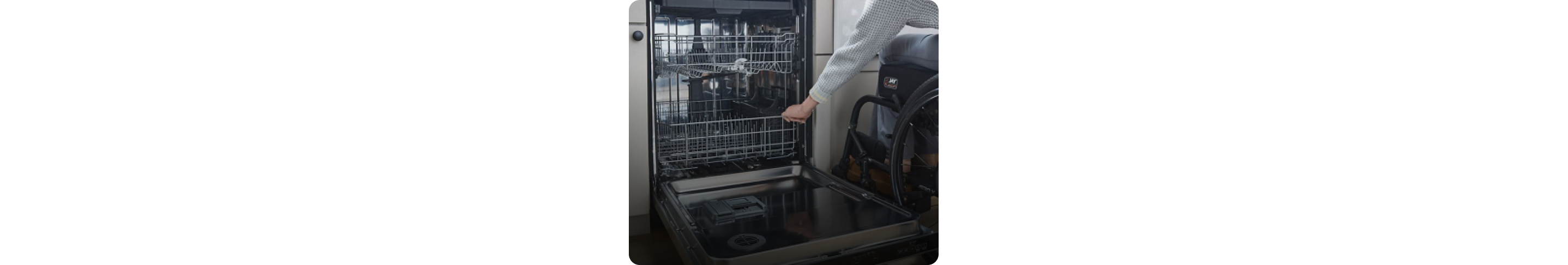 A person rolling the Spin&Load Rack back into the dishwasher