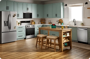 A bright kitchen with blue-green cabinets and a suite of stainless steel Whirlpool® Appliances